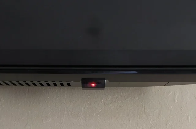 Television with standby light glowing.