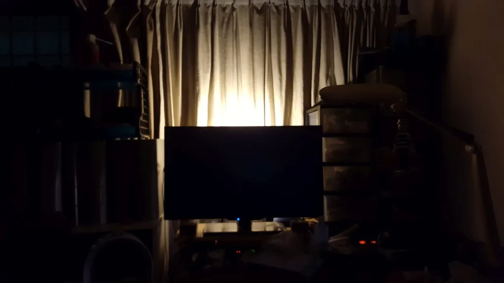TV in a dark room with curtains closed